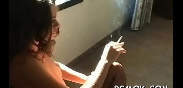  Busty chick playing with her titties whilst smoking a cigarette